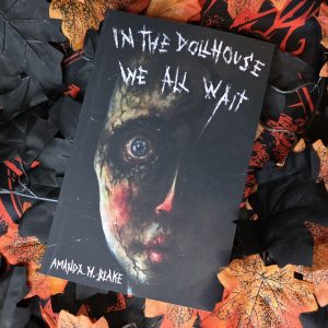 In the Dollhouse We All Wait by Amanda M. Blake